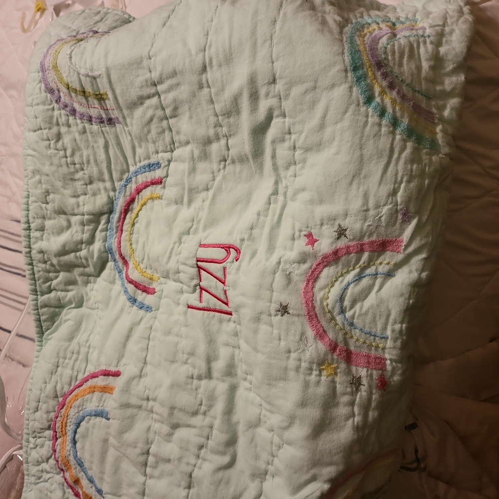 Pillow cover. Embroidered with Izzy in hot pink.